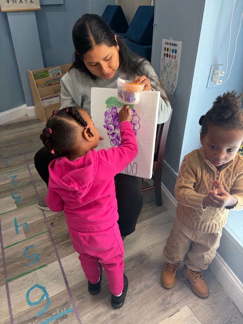 Children painting together in classroom